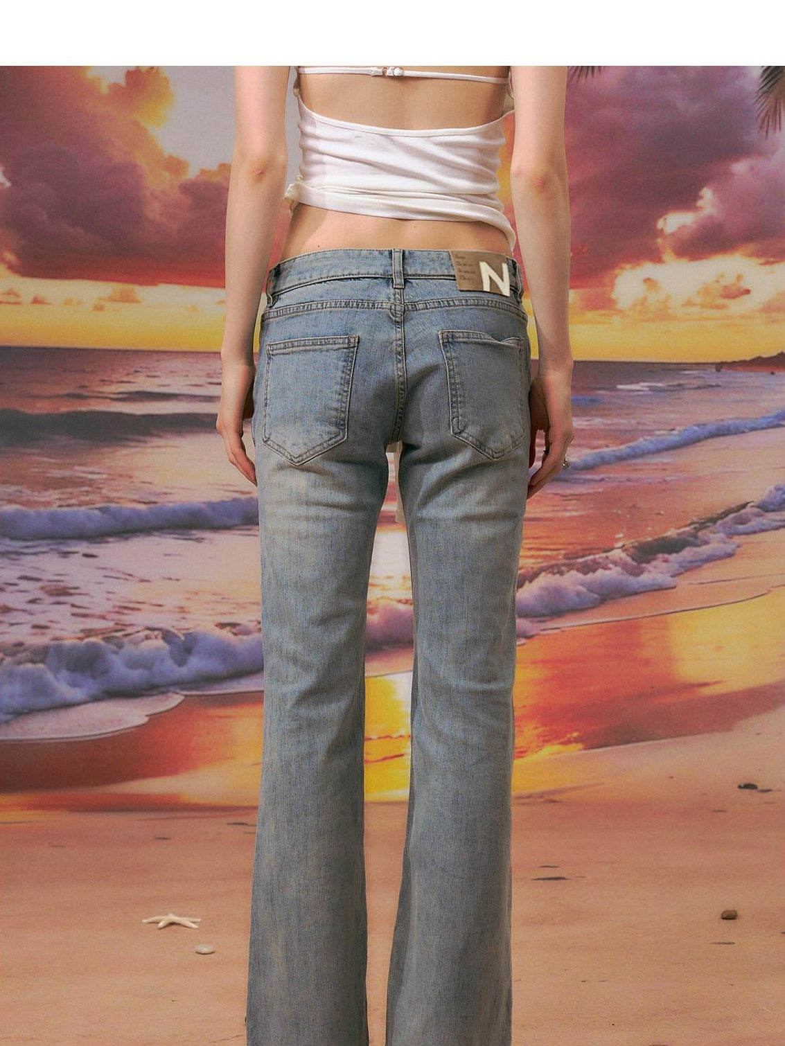 The NeverMore Durable Distressed Relaxed Low Rise Light Blue Denim Women Straight Leg Jeans