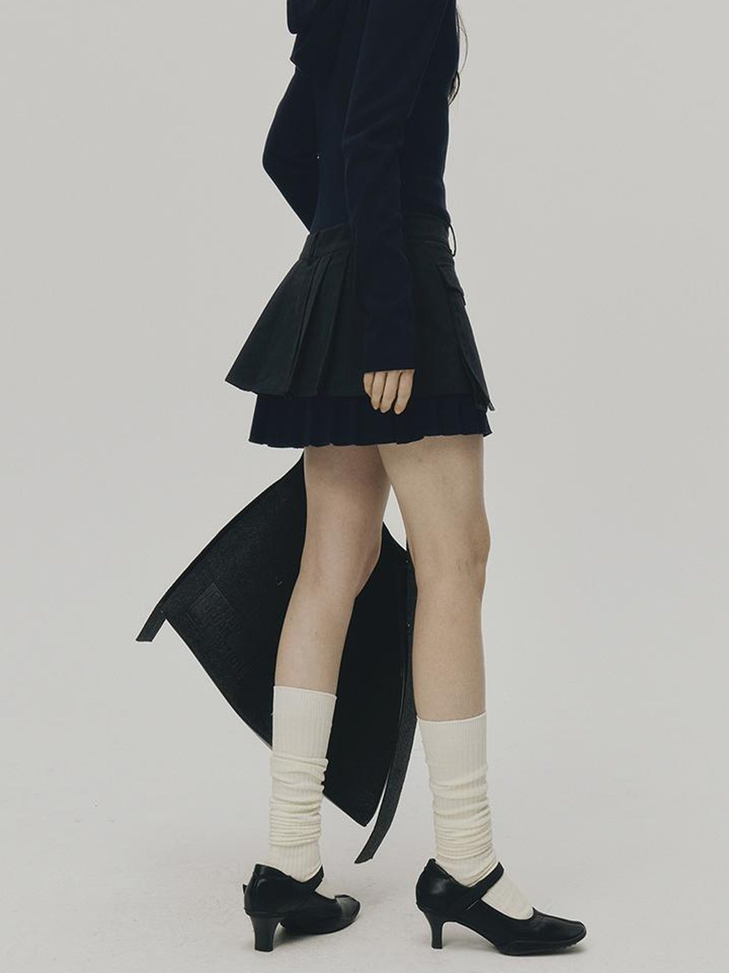 FUSSED Structured Pleated Mini Skirt With Asymmetric Pocket In Dusk Blue