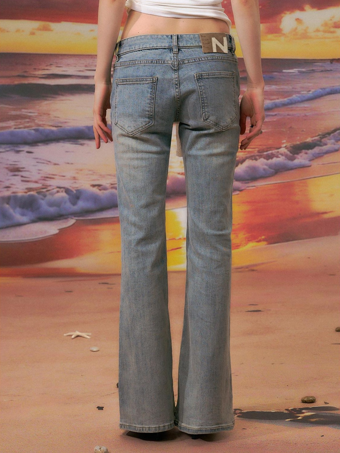 The NeverMore Durable Distressed Relaxed Low Rise Light Blue Denim Women Straight Leg Jeans