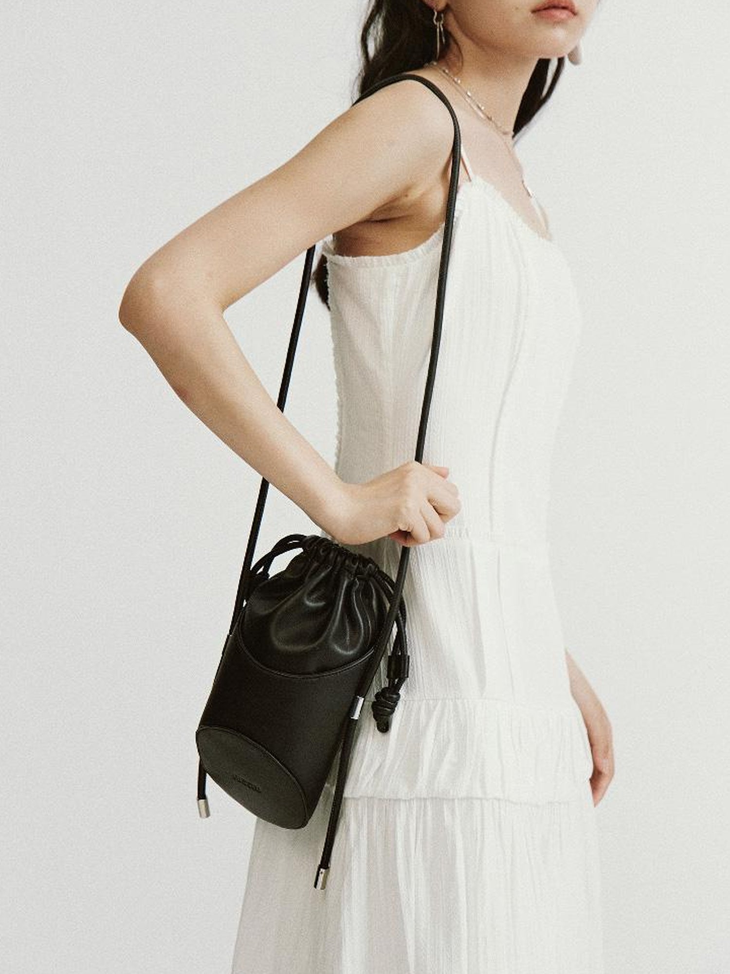 FUSSED Asymmetrical Geometric Drawstring Pu Crossbody Bag Black